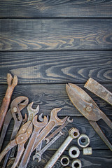 Rusty Old Tools on black vintage wood background.