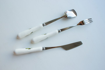Fototapeta premium cutlery dessertware fork spoon knife on a white background with a rose on the handle