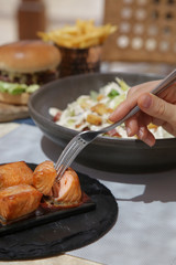  Close up image of a fork and roasted salmon pieces 