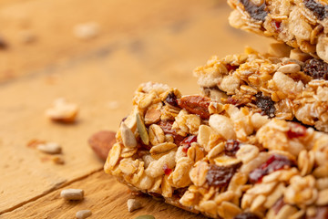 granola bars and nuts on a wooden background with space for design, horizontal photo, diet, proper nutrition