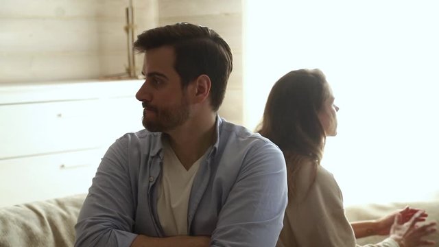 Couple sitting apart avoid talking after fight or conflict