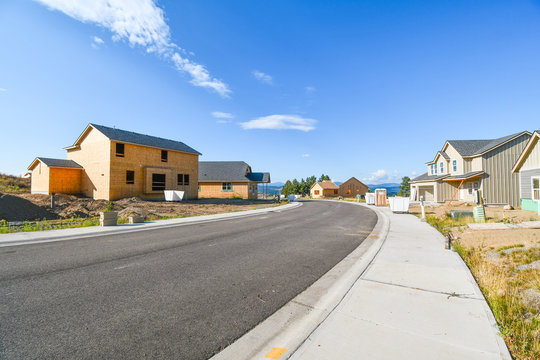 A New Home Subdivision Going Up In An American Subdivision With Homes At Varying Degrees Of Construction