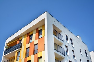 Obraz premium Modern apartment buildings on a sunny day with a blue sky. Facade of a modern apartment building