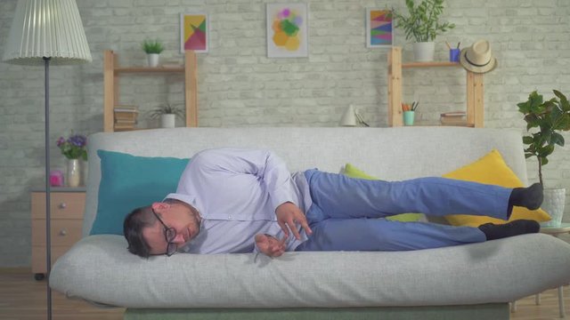 man with a smartphone had an epileptic seizure at home on the couch