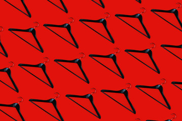 Fashion clothes hanger pattern on red background.