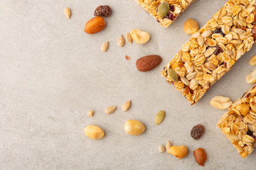 granola bars with nuts on a light background with space for design, horizontal photo, diet, proper nutrition