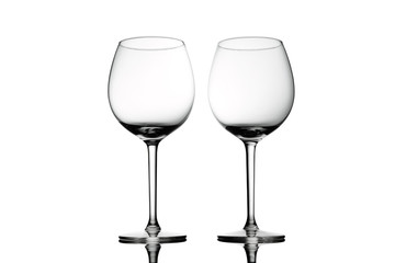 Empty elegant Crystal wine glasses with wine isolated on white background. Alcohol beverage card backdrop.
