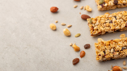 granola bars with nuts on a light background with space for design, horizontal photo, diet, proper nutrition