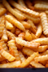 Curly fries in a box. Take away food. Selective focus.