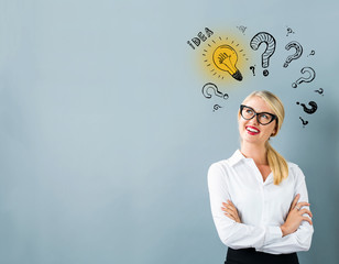 Idea light bulbs with question marks with young woman in a thoughtful face