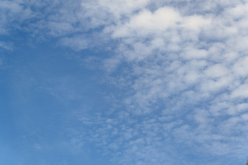 blue sky with airy white clouds