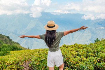 Beautiful happy young woman in mountains in the background of fog © travnikovstudio