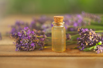 Fototapeta na wymiar lavender essential oil in beautiful bottle on table