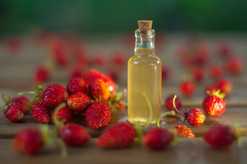 Essence of Wild strawberry on table in beautiful glass jar