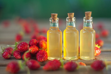 Essence of Wild strawberry on table in beautiful glass jar