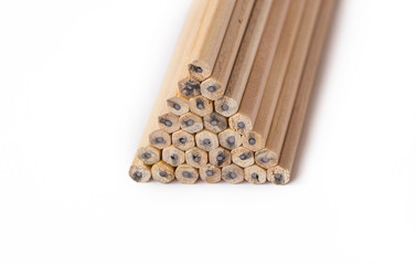 pyramid of wooden unsharpened pencils on a white background