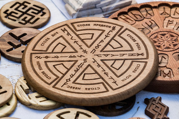 Wooden household items with ancient Slavic Nordic handmade symbols crests, runes, hats.