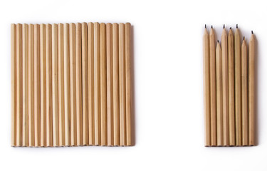 new and used wooden pencils lie nearby . on a white background