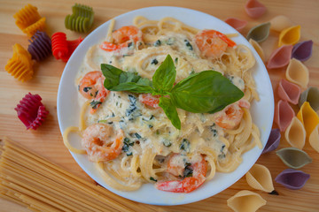 delicious delicious spaghetti with shrimps and basil on  plate