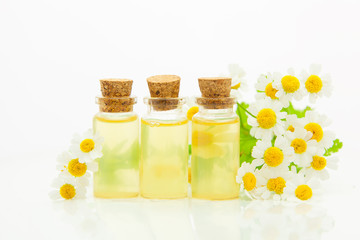 Essence of flowers on table in beautiful glass bottle