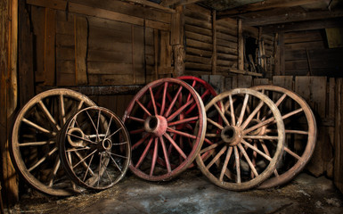 Fototapeta na wymiar Old wagon wheels in barn in central Virginia.