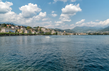 Fototapeta premium Landscape of Lake Lugano with Lugano city on background in summer day.