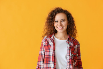 Happy African-American woman on color background