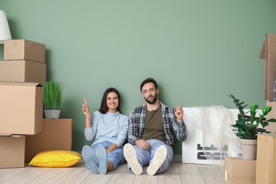 Young couple with cardboard boxes after moving into new house