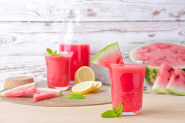 Glass of fresh watermelon juice on table