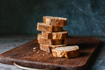 Slices of fresh bread on wooden board