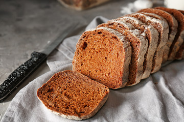 Slices of fresh bread with knife on table