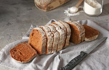 Slices of fresh bread with knife on table