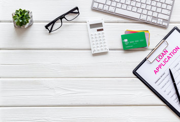loan application with bank cards and keyboard on white wooden background top view mock up