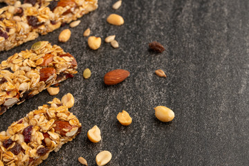 granola bars with nuts on a dark background with space for design, horizontal photo, diet, proper nutrition