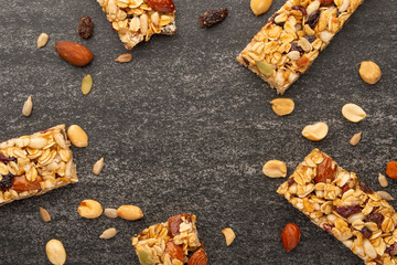 granola bars with nuts on a dark background with space for design, horizontal photo, diet, proper nutrition