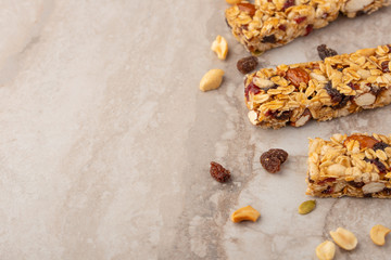 granola bars with nuts on a light background with space for design, horizontal photo, diet, proper nutrition