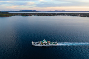 Aerial view of car ferry with Ugljan island in background at dusk, Croatia