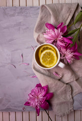 Obraz na płótnie Canvas Warm cup of tea with pink flowers