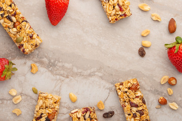 granola bars with nuts and strawberries on a light background with space for design, horizontal photo, diet, proper nutrition