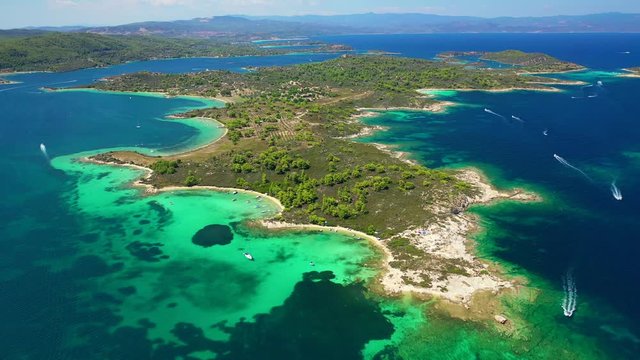 Aerial drone video of famous beaches and turquoise sea in Diaporos island near iconic bay of Vourvourou, Sithonia Peninsula, Halkidiki, North Greece