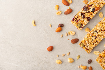 granola bars with nuts on a light background with space for design, horizontal photo, diet, proper nutrition