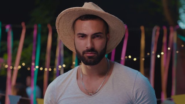 Appealing caucasian guy with sexy expression looking pointing on camera hanging out and dancing at night party. Fun and joy concept.