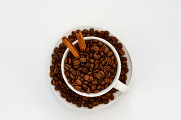 Coffee cup with roasted coffee beans on white. View from top
