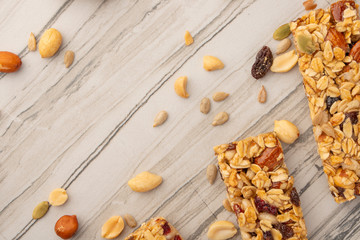 granola bars with nuts on a light background with space for design, horizontal photo, diet, proper nutrition