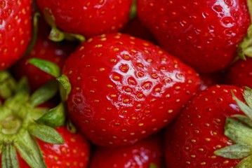 natural vegetable red background from ripe strawberries in a heap
