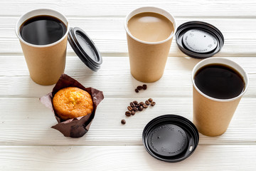 Caution: contents hot. Coffee to go on white wooden background