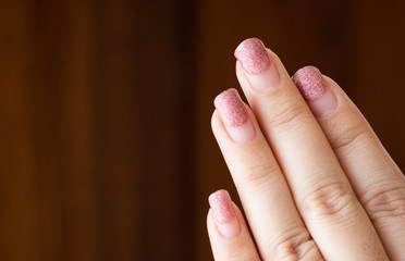 Old color painting on nails after long time paint,close up beautiful pink glitter ombre gel nail art on woman fingernail after one month. © Arkom