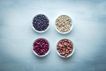 Beans of Different Colors, in Bowls Each Group, on a White Background