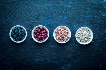 Beans of Different Colors, in Bowls Each Group, on a Black Background