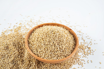 A wooden bowl of miscellaneous grains buckwheat on a white background